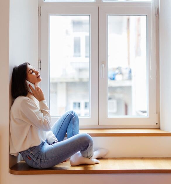woman sitting in window